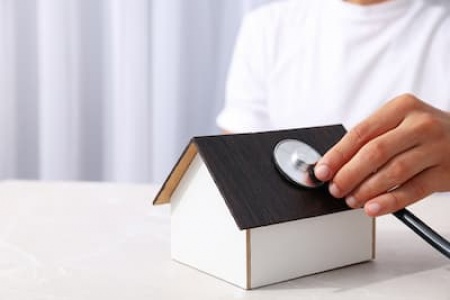 a-toy-wooden-house-with-a-stethoscope-2025-03-24-23-52-07-utc (1).jpg